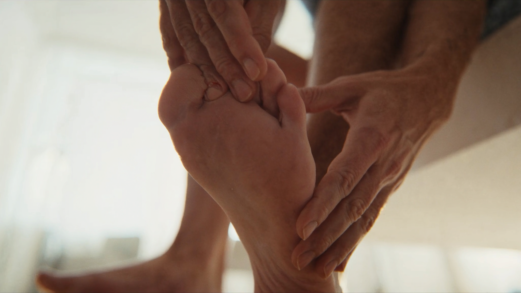 Diabetic patient checking the bottom of their foot at home